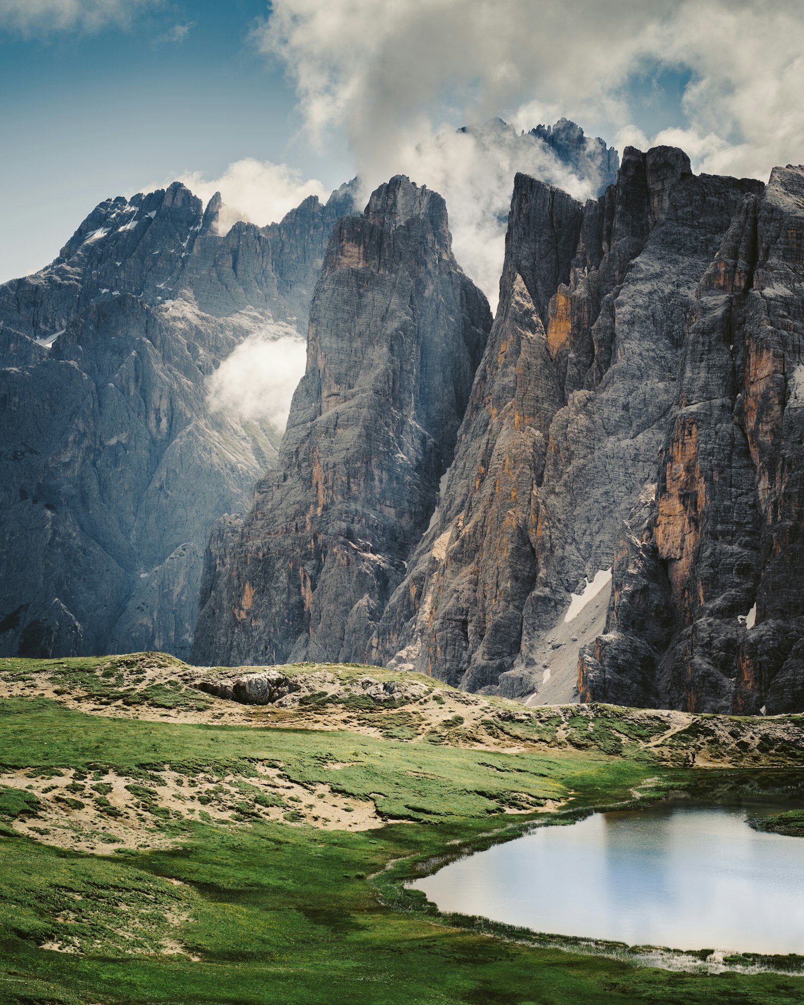 Sheer Dolomite rock walls rising above a mountain path