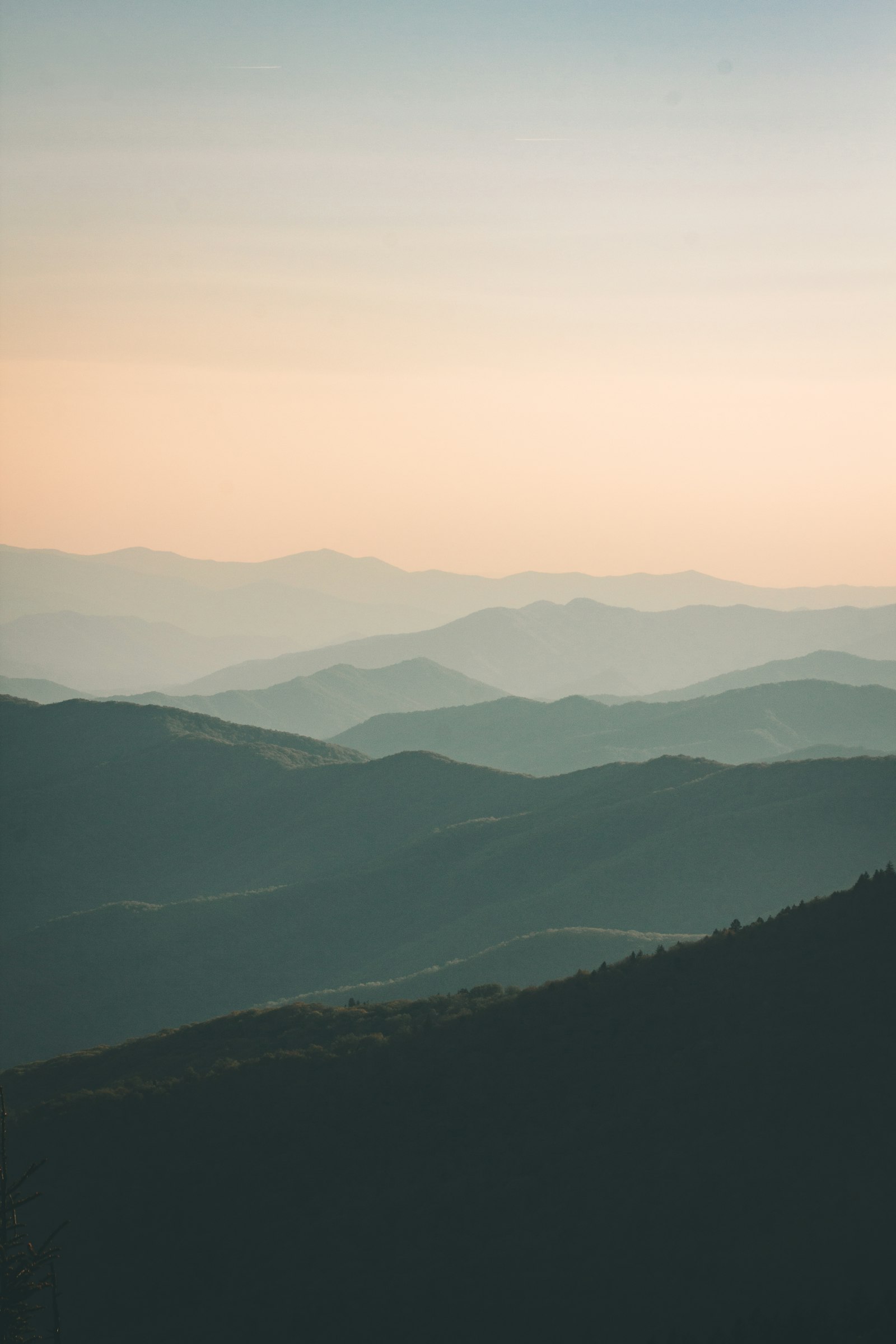 Soft Tuscan hills fading into layers of morning mist